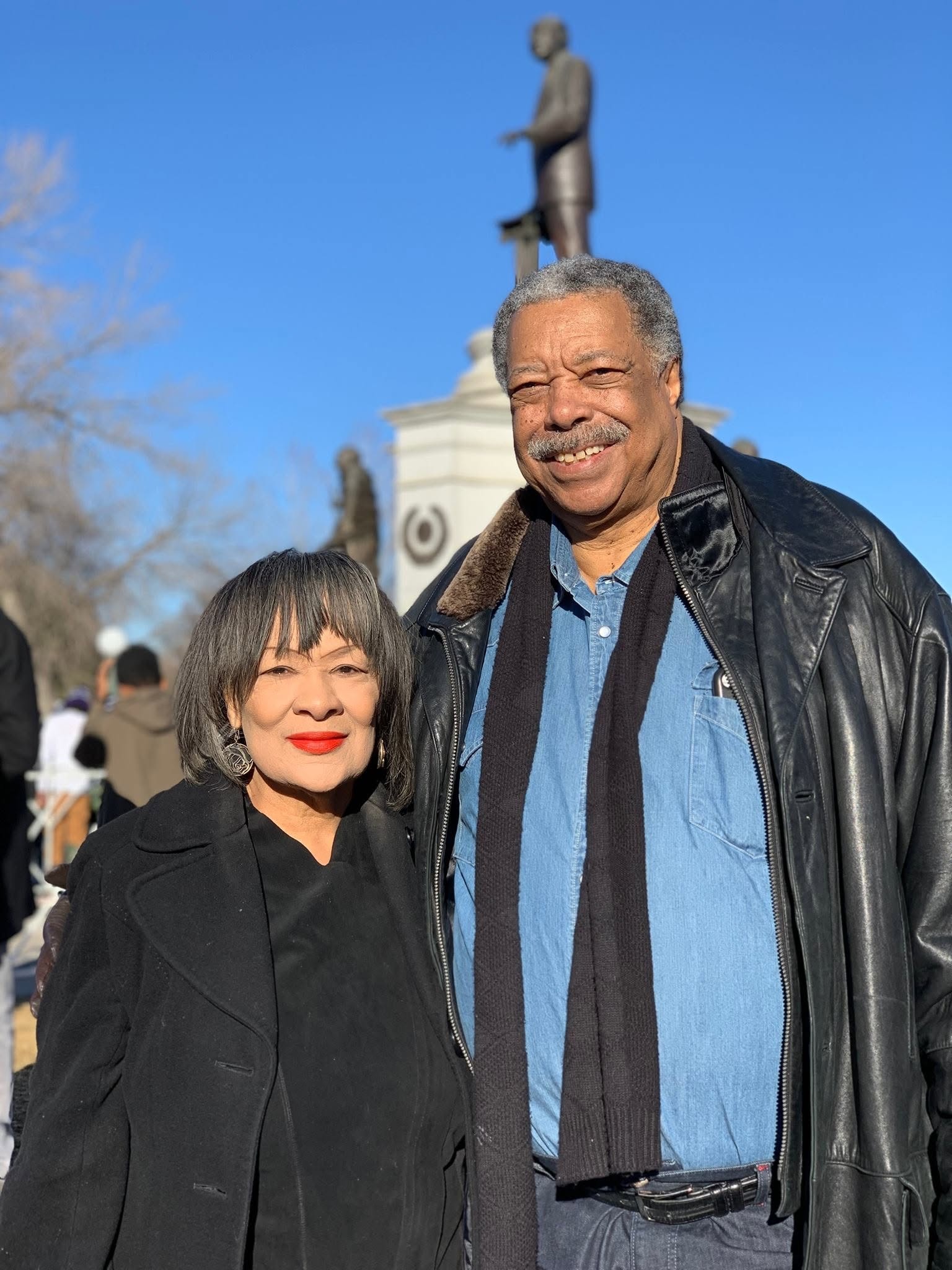 Former Denver Mayor Wellington Webb and former Colorado State Representative Wilma Webb smiling together outdoors